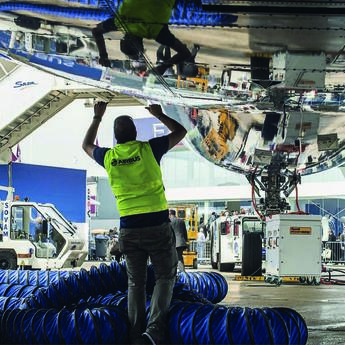 Maintenance technician working on an aircraft to ensure operational safety.