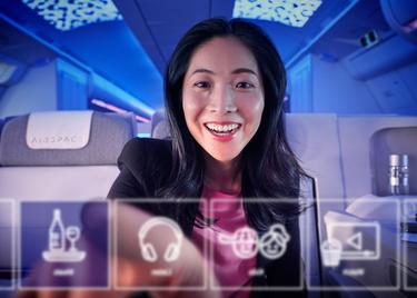 Women touching IFE screen by passengers in Airspace cabin