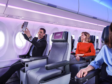 Man taking a selfie on board of the A220