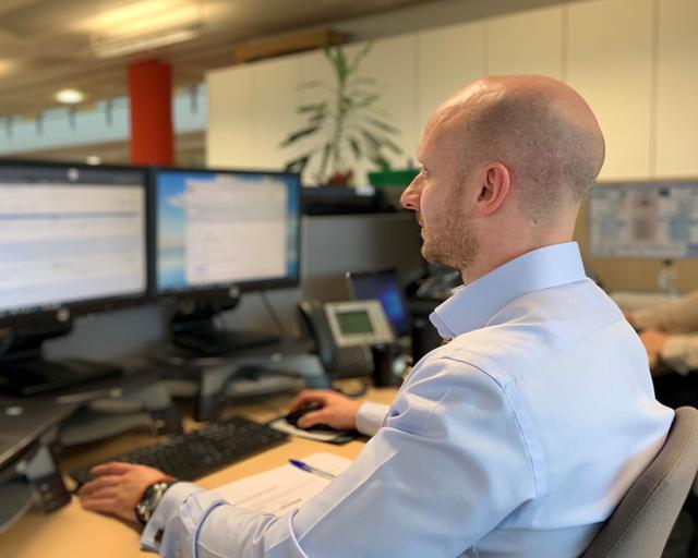 Person working in front of screens