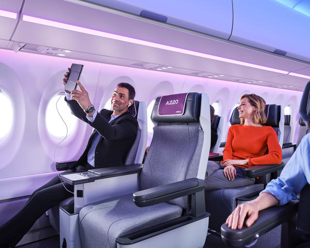 A220 Airspace cabin Man taking a selfie on board of the A220