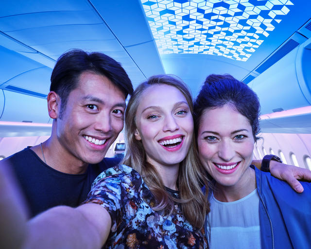 A330 Airspace Cabin Three people taking a selfie in an airspace cabin