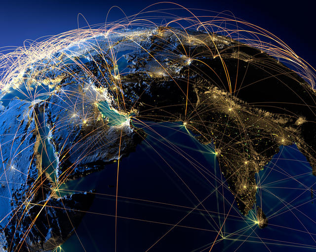 Planet Earth at night, illuminated by city lights, surrounded by a light network, representing the main air routes. Planet Earth at night, illuminated by city lights, surrounded by a light network, representing the main air routes.