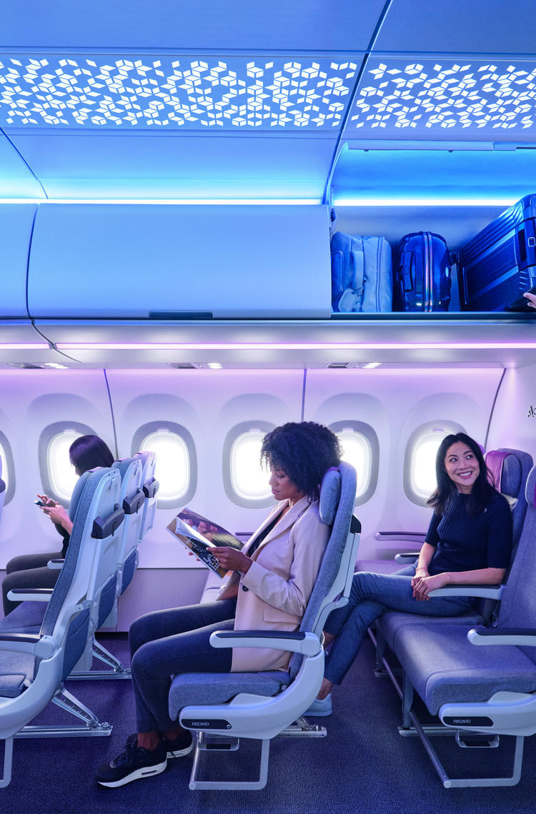 A320 Airspace Cabin with passengers A320 Airspace Cabin - man loading lugagge to XL Bin