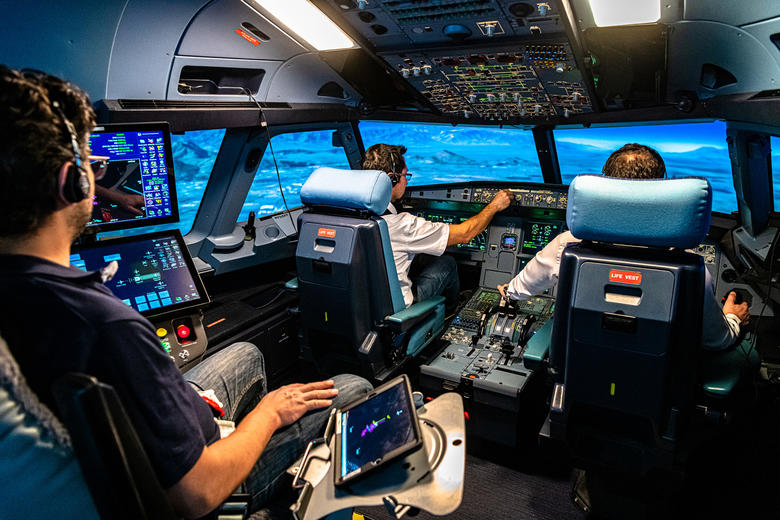 Pilots engaging in a flight training session in a full flight simulator